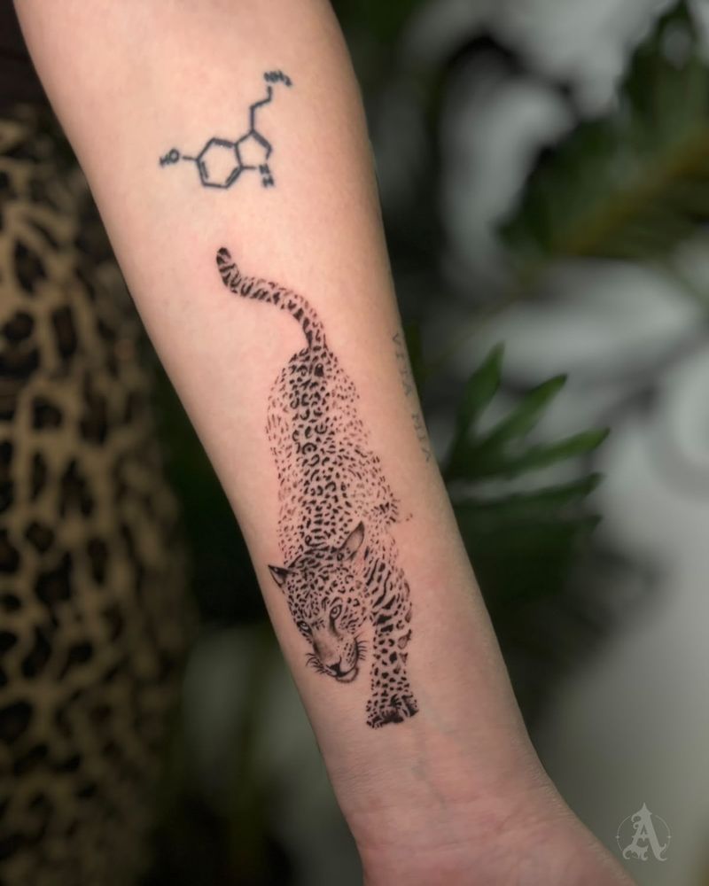 Tatuaje de guepardo acechando en el brazo, fine line en negro y gris